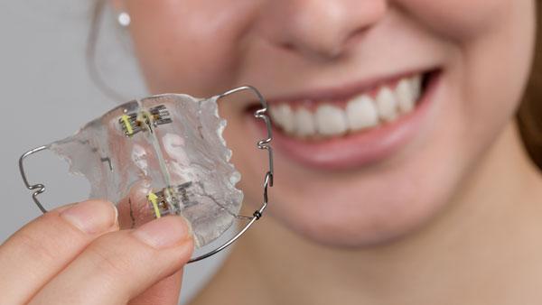 Girl holding removable brace